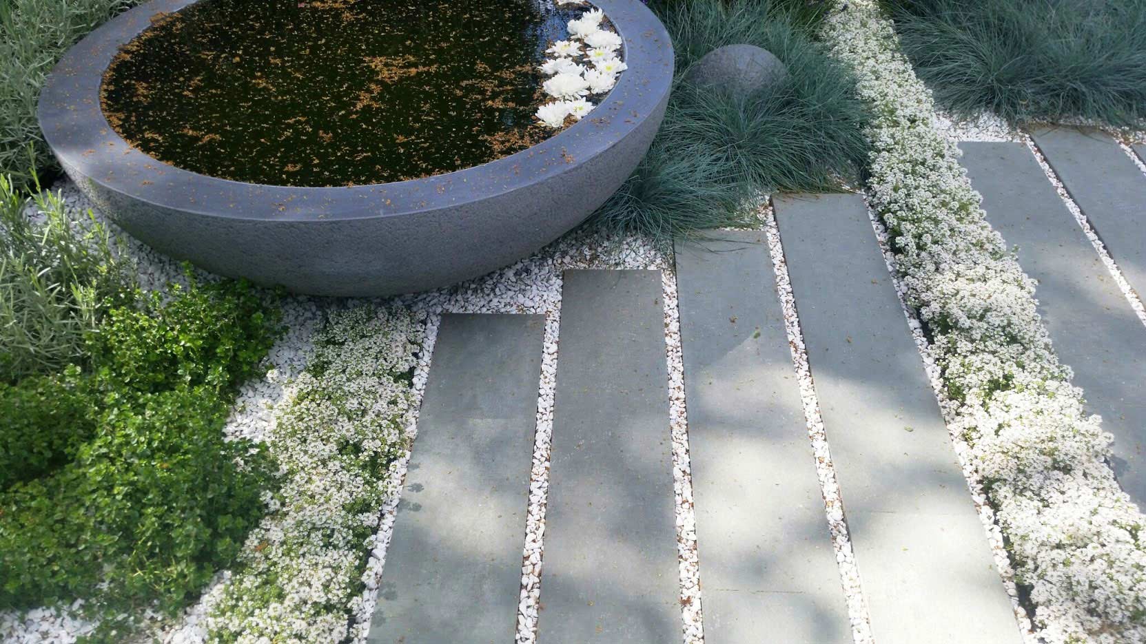Waterbowl and stone paving in a garden designed by Rae Wilkinson