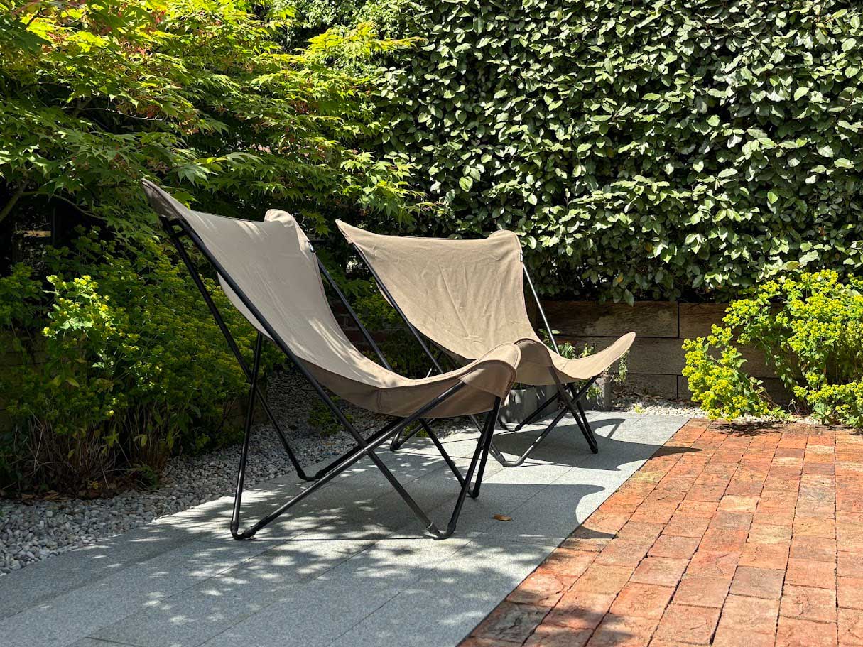 Seating in a barn courtyard garden designed by Rae Wilkinson